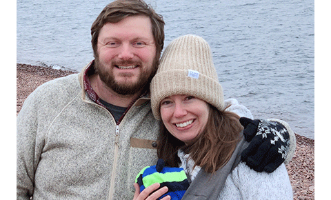 Smiling couple at beach in cool weather